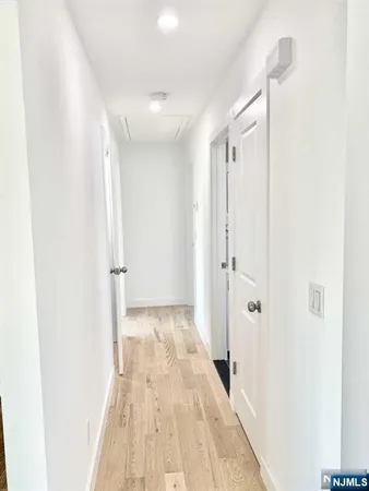 a view of a big room with wooden floor and a bathroom