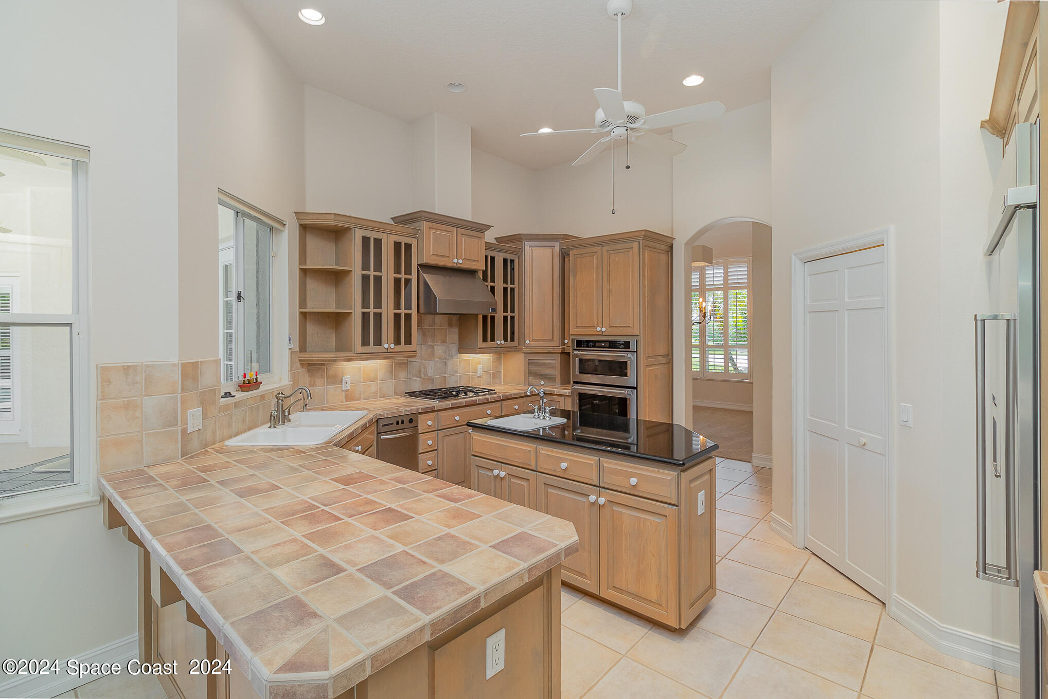 465 Baytree Drive Melbourne, FL 32940 - Photo 13 of 36 a kitchen with stainless steel appliances granite countertop a stove refrigerator and cabinets