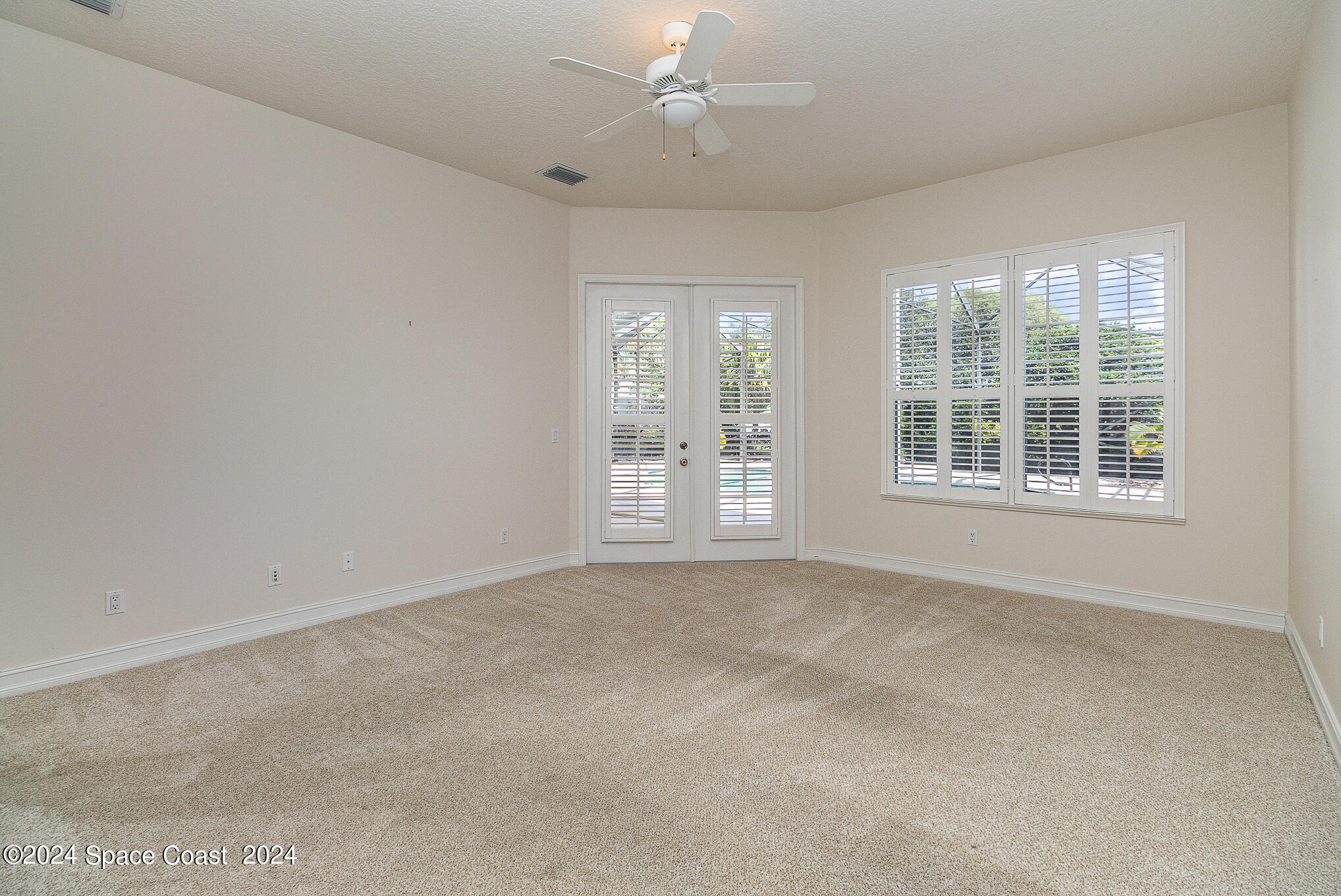 465 Baytree Drive Melbourne, FL 32940 - Photo 17 of 36 an empty room with windows and entrance