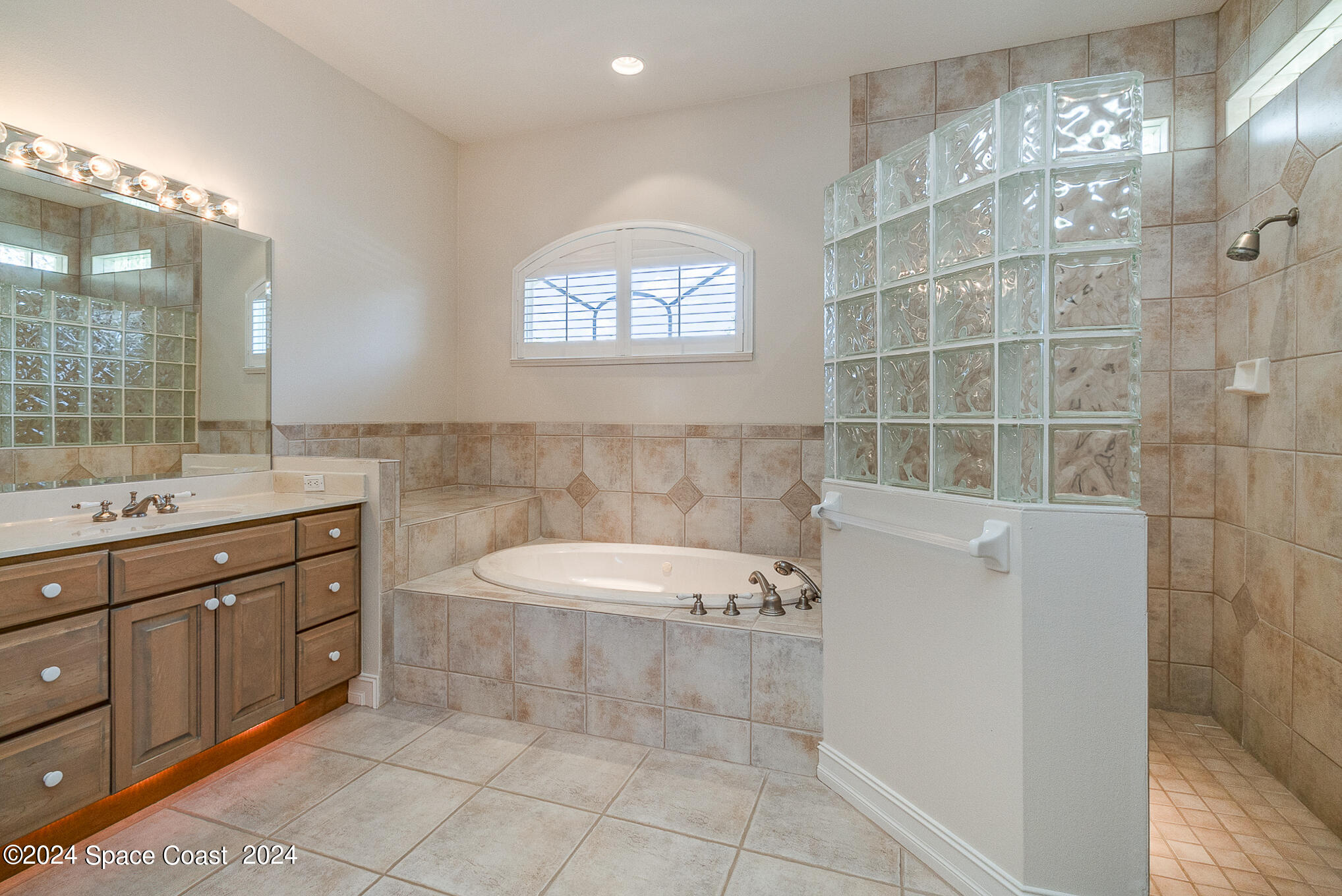 465 Baytree Drive Melbourne, FL 32940 - Photo 20 of 36 a spacious bathroom with a tub sink and mirror