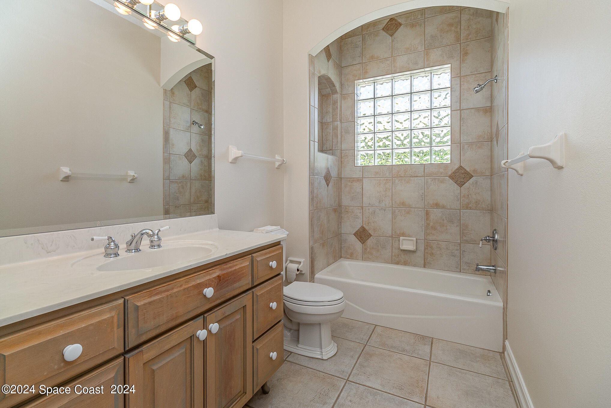 465 Baytree Drive Melbourne, FL 32940 - Photo 25 of 36 a bathroom with a granite countertop sink a toilet and shower