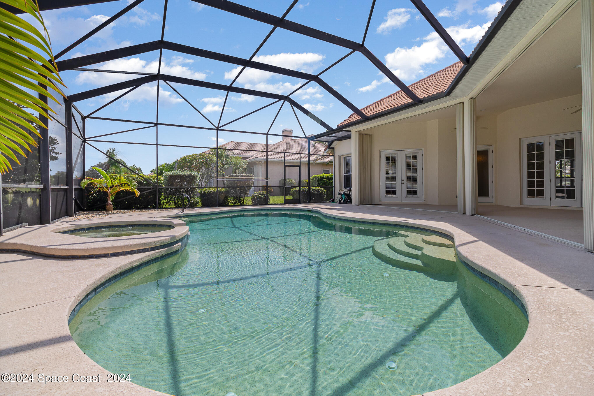 465 Baytree Drive Melbourne, FL 32940 - Photo 32 of 36 a view of a patio with a table and chairs under an umbrella