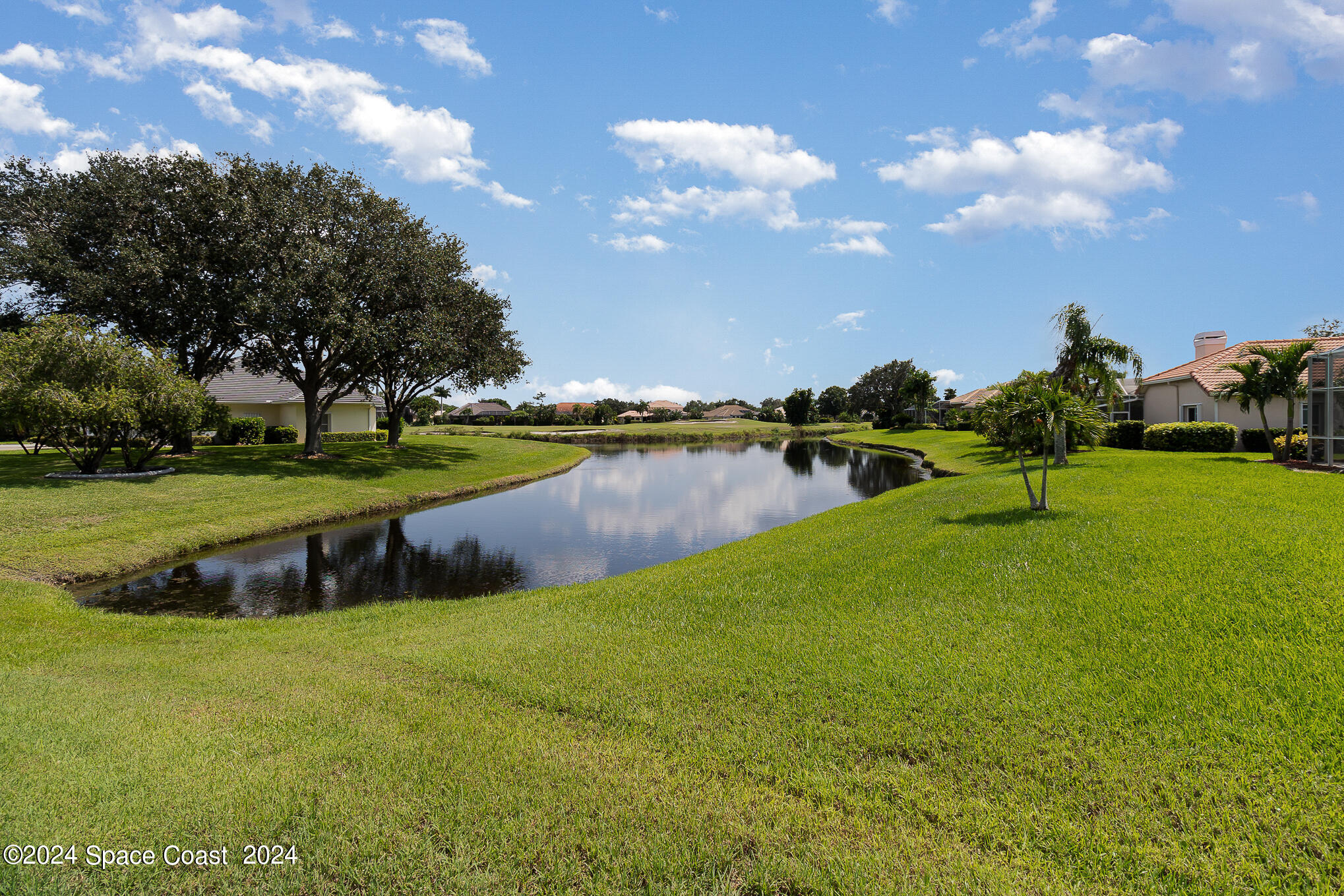 465 Baytree Drive Melbourne, FL 32940 - Photo 35 of 36 a view of a golf course with a lake