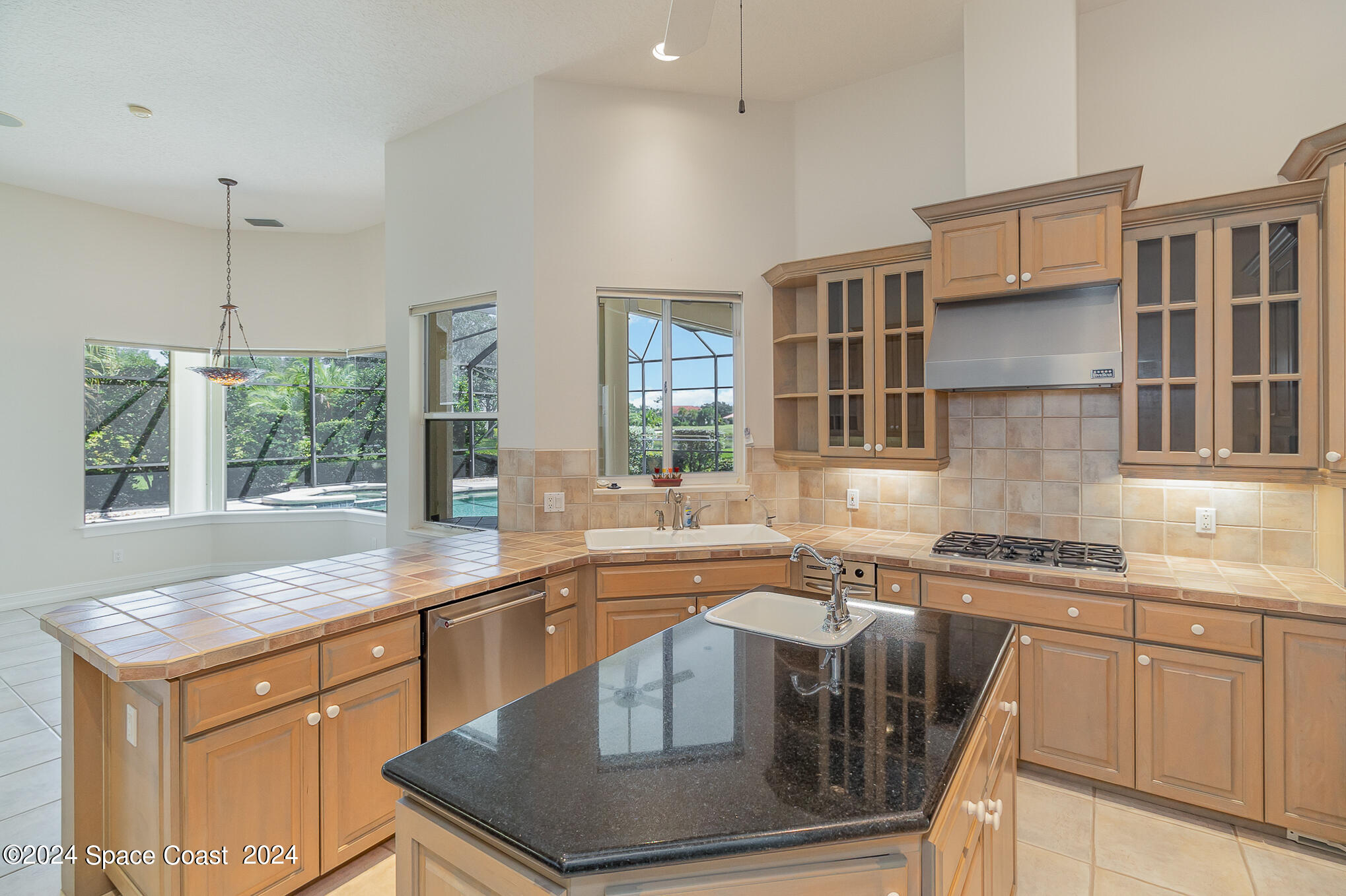 465 Baytree Drive Melbourne, FL 32940 - Photo 4 of 36 a kitchen with stainless steel appliances granite countertop a sink stove and cabinets