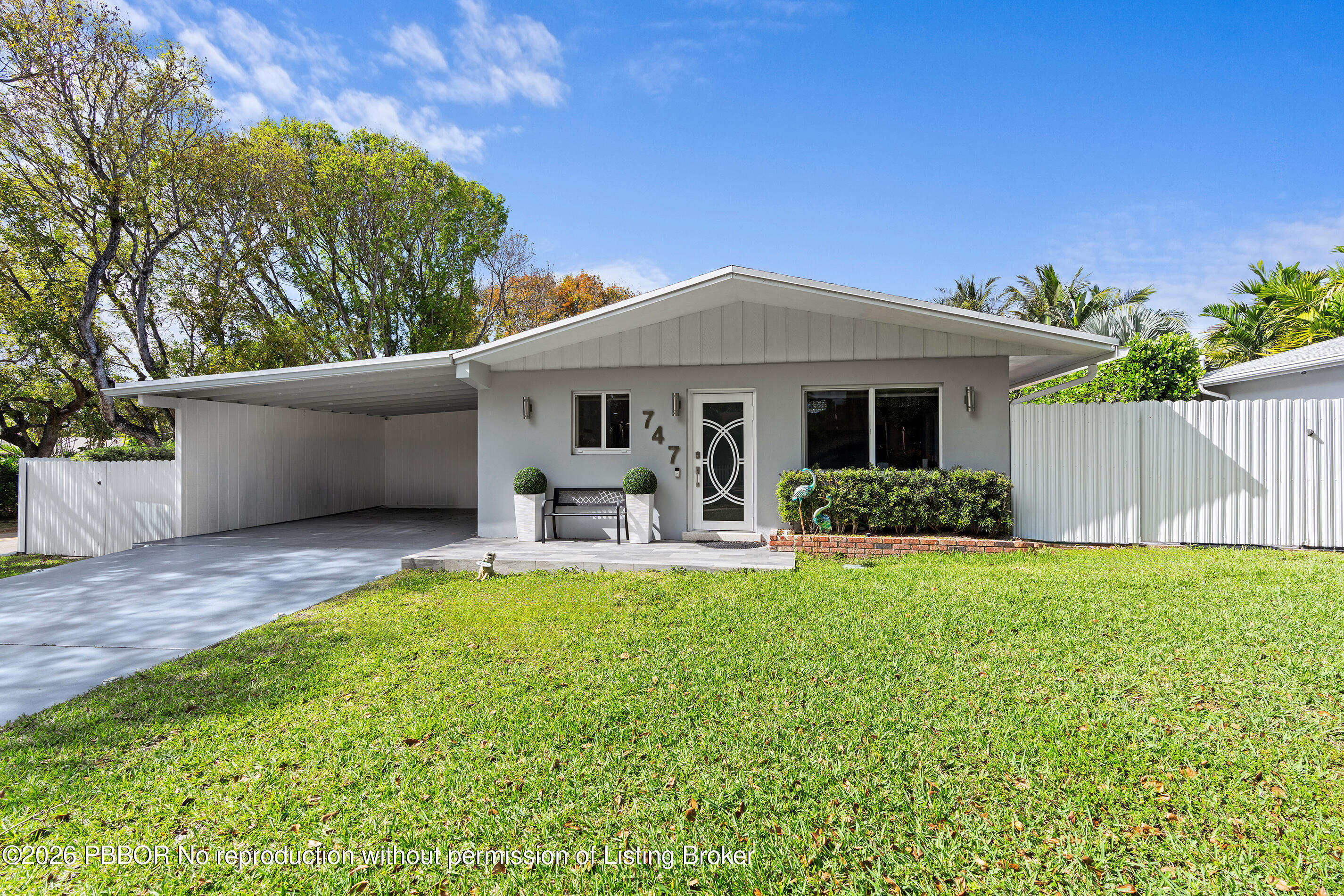 747 Avon Road West Palm Beach, FL 33401 - Photo 24 of 29 a front view of a house with patio