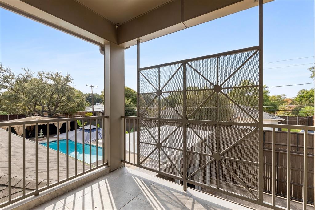 4436 Thunder Road Dallas, TX 75244 - Photo 18 of 33 Balcony with a metal railing and privacy screen, overlooking a swimming pool and covered patio