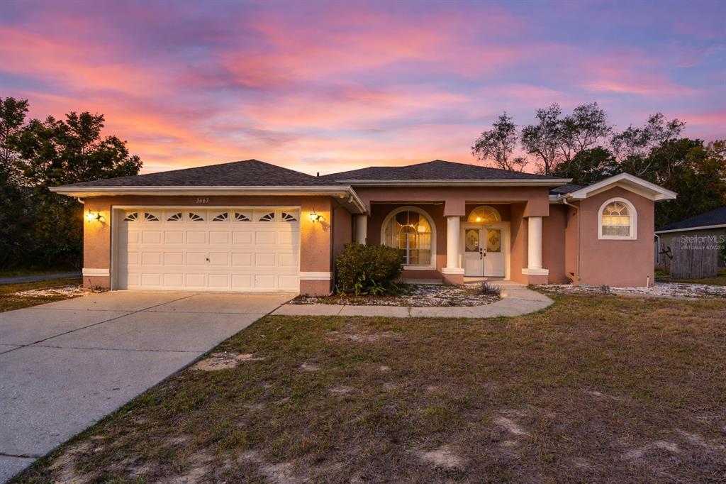 a front view of a house with a yard and garage