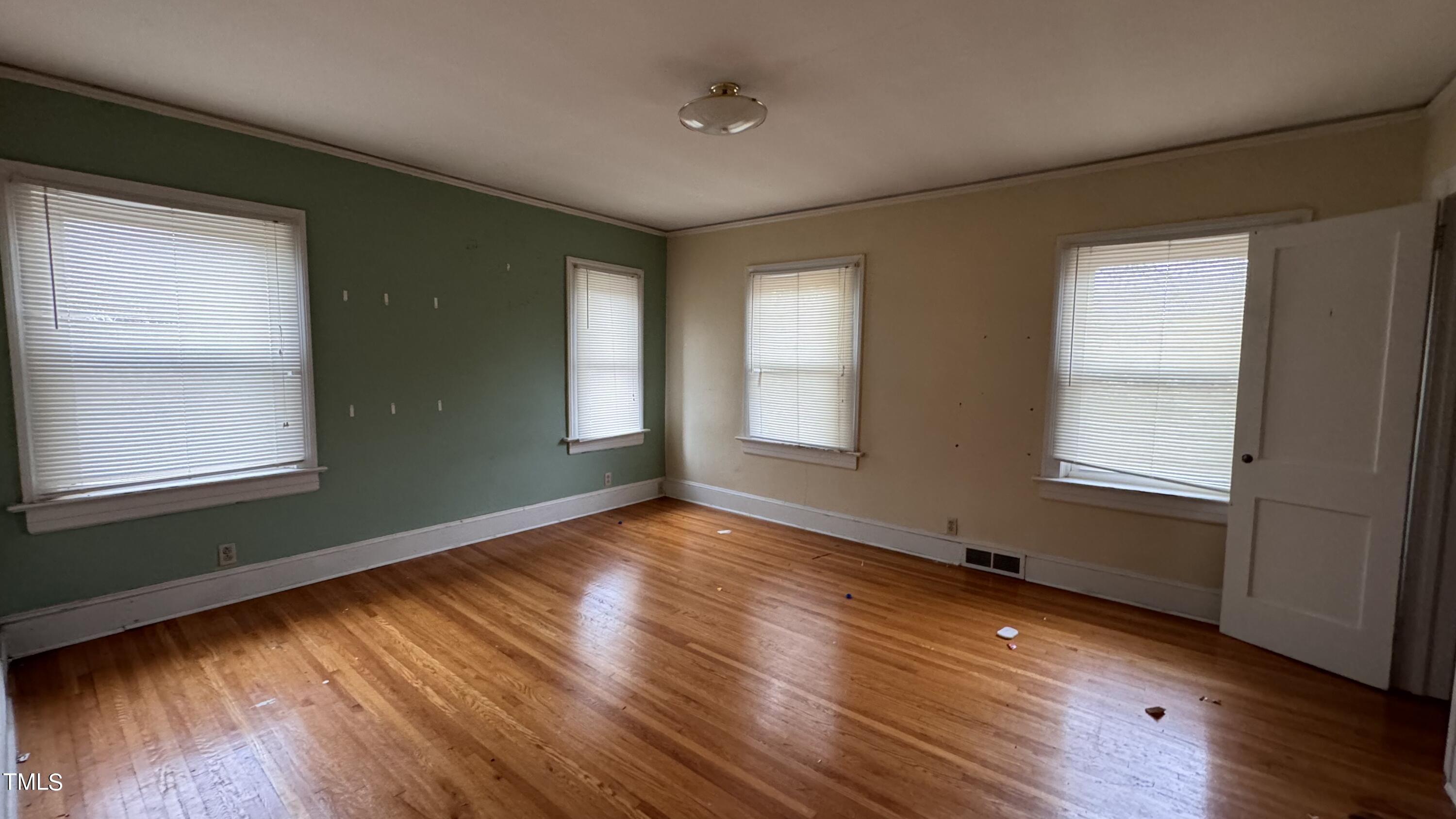 116 Horne Street Raleigh, NC 27607 - Photo 11 of 16 an empty room with wooden floor and windows