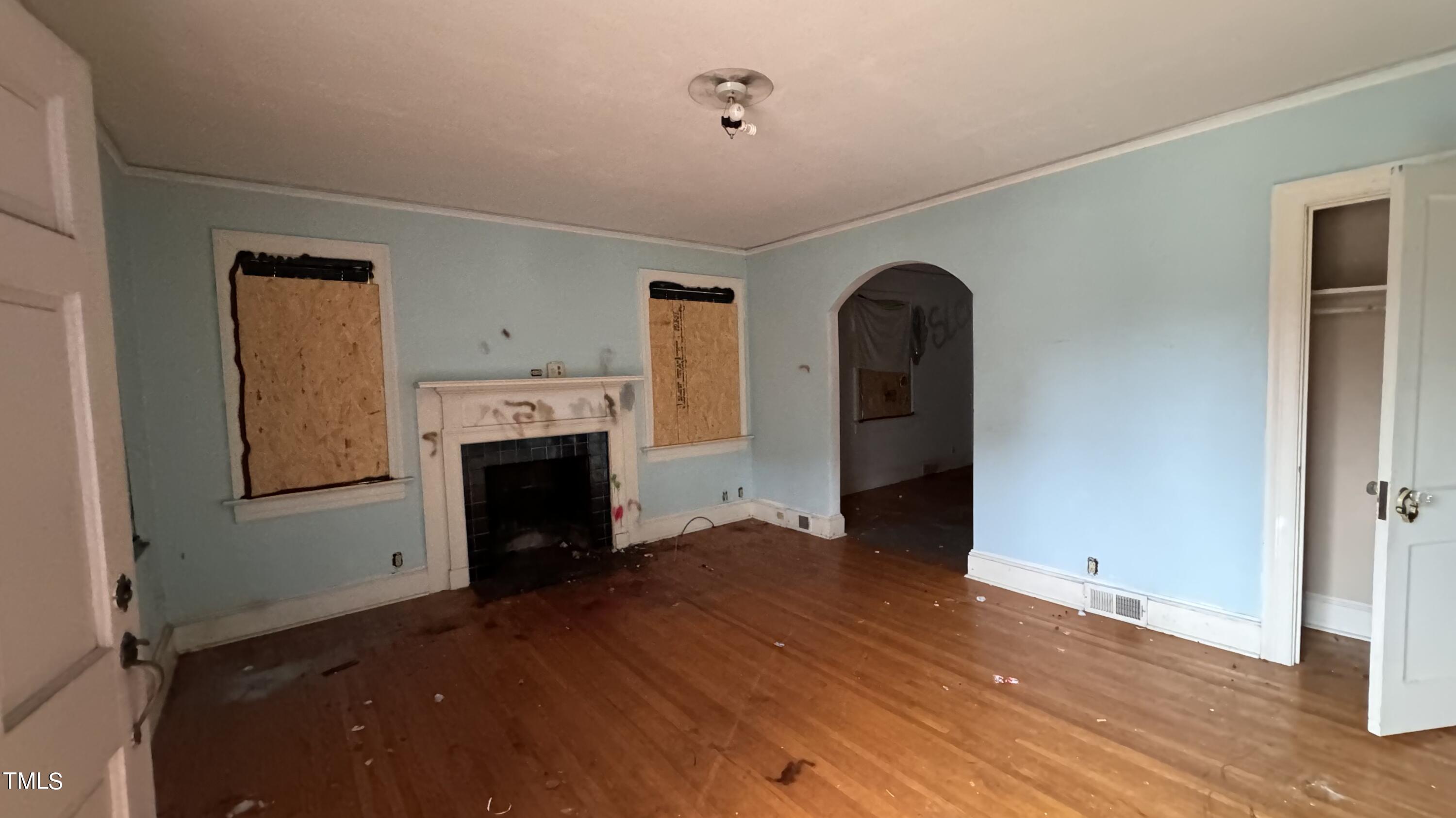 116 Horne Street Raleigh, NC 27607 - Photo 2 of 16 a view of a livingroom with wooden floor and a fireplace