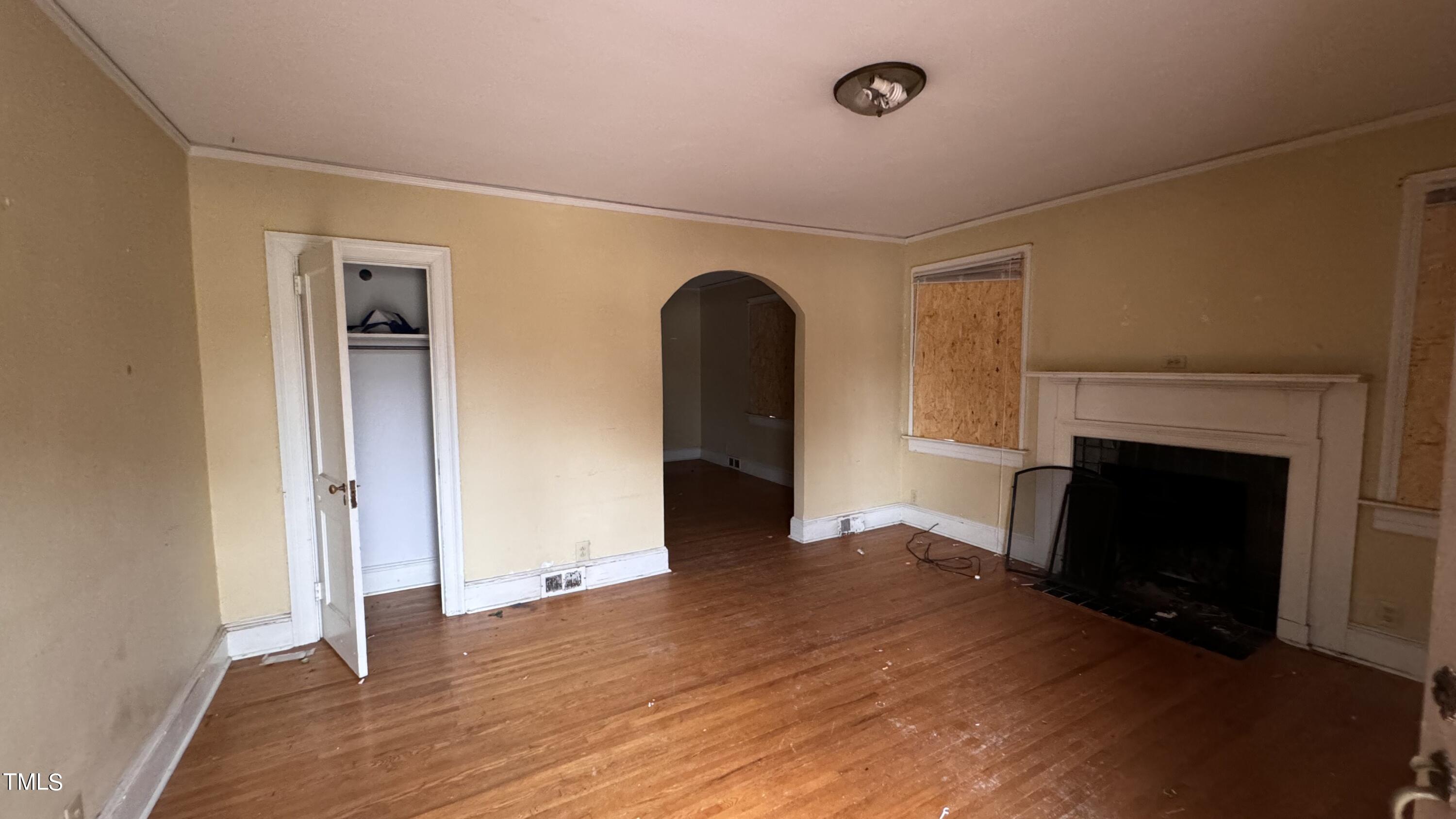 116 Horne Street Raleigh, NC 27607 - Photo 7 of 16 a view of a livingroom with a fireplace wooden floor and cabinet