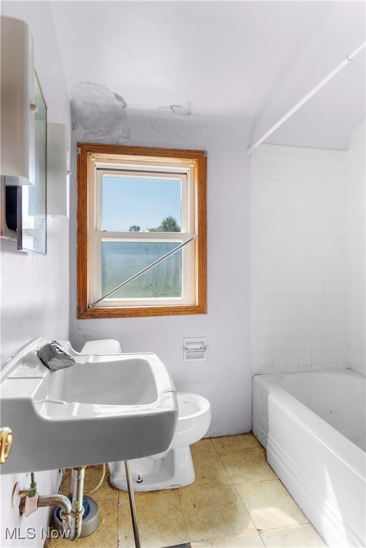 6512 Warren - Sharon Road Brookfield, OH 44403 - Photo 21 of 21 Bathroom featuring tiled shower / bath, toilet, and tile patterned flooring