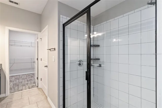 a bathroom with a glass shower door