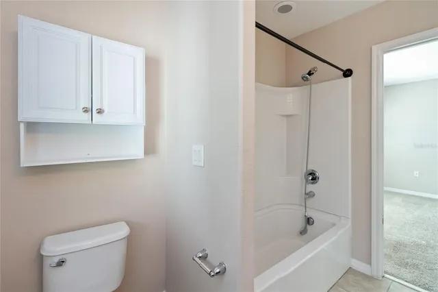 a bathroom with a bathtub a toilet and a shower