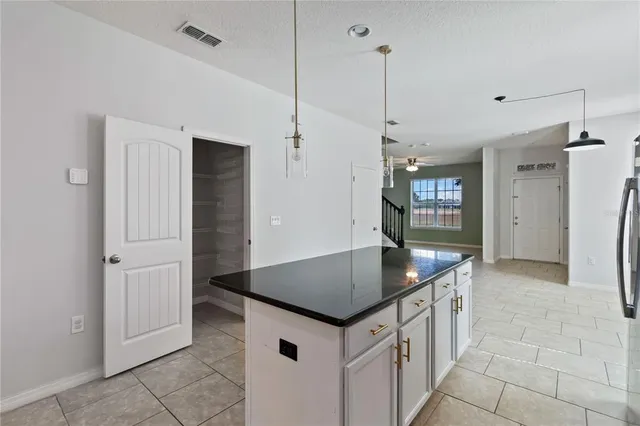 a kitchen with stainless steel appliances granite countertop a sink and a refrigerator