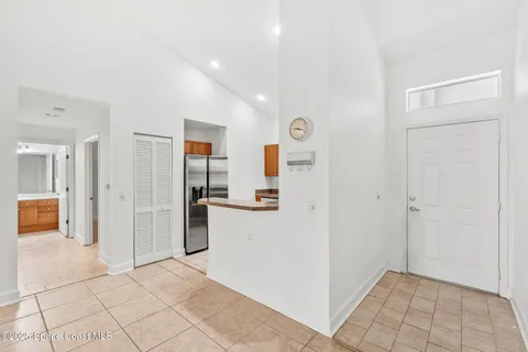 a view of a hallway with wooden shelves