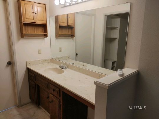 1014 Sherri Street Ridgecrest, CA 93555 - Photo 6 of 23 a bathroom with a sink and a mirror