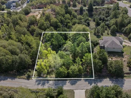 an aerial view of house with yard and outdoor seating