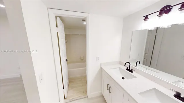 a bathroom with a double vanity sink and mirror