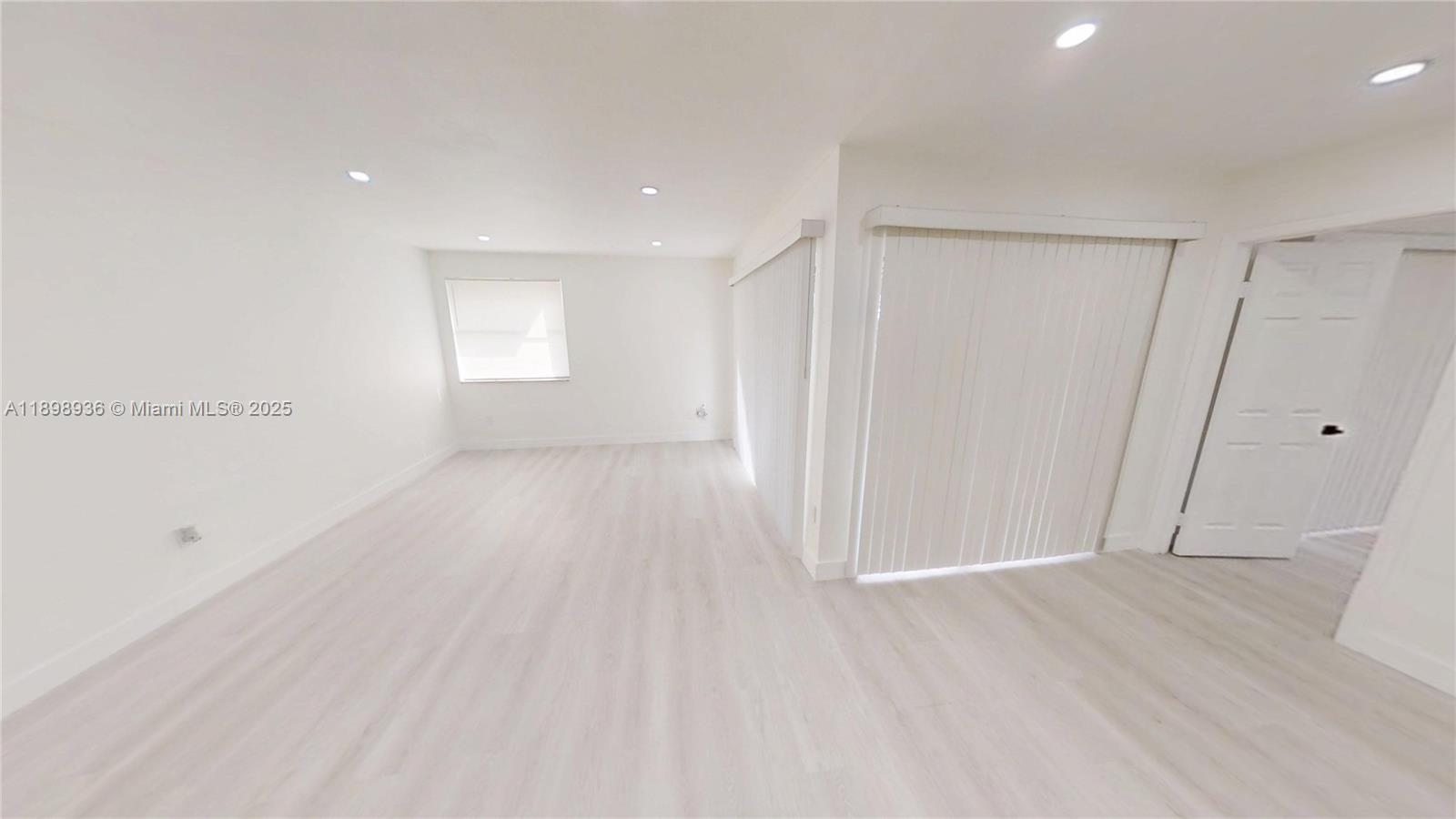 20230 Northeast 3rd Court, Unit 6 Miami, FL 33179 - Photo 20 of 44 a view of a room with wooden floor