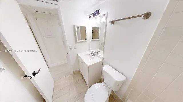 a bathroom with a sink a toilet a mirror and shower