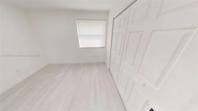 a view of a big room with kitchen and windows