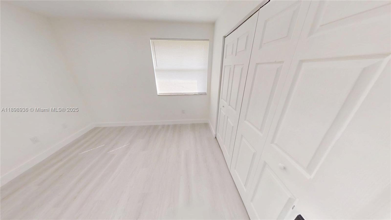 20230 Northeast 3rd Court, Unit 6 Miami, FL 33179 - Photo 30 of 44 a view of a room with wooden floor