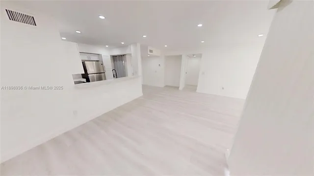 a view of kitchen with furniture and refrigerator