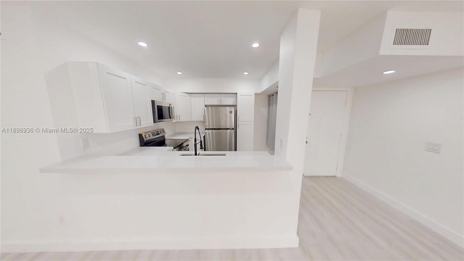 20230 Northeast 3rd Court, Unit 6 Miami, FL 33179 - Photo 35 of 44 a view of kitchen with furniture and refrigerator