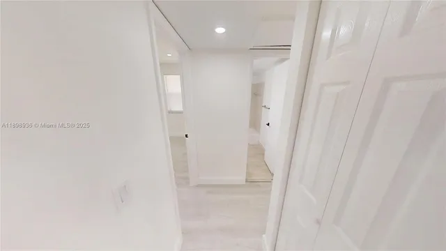 a view of a hallway with washer and dryer