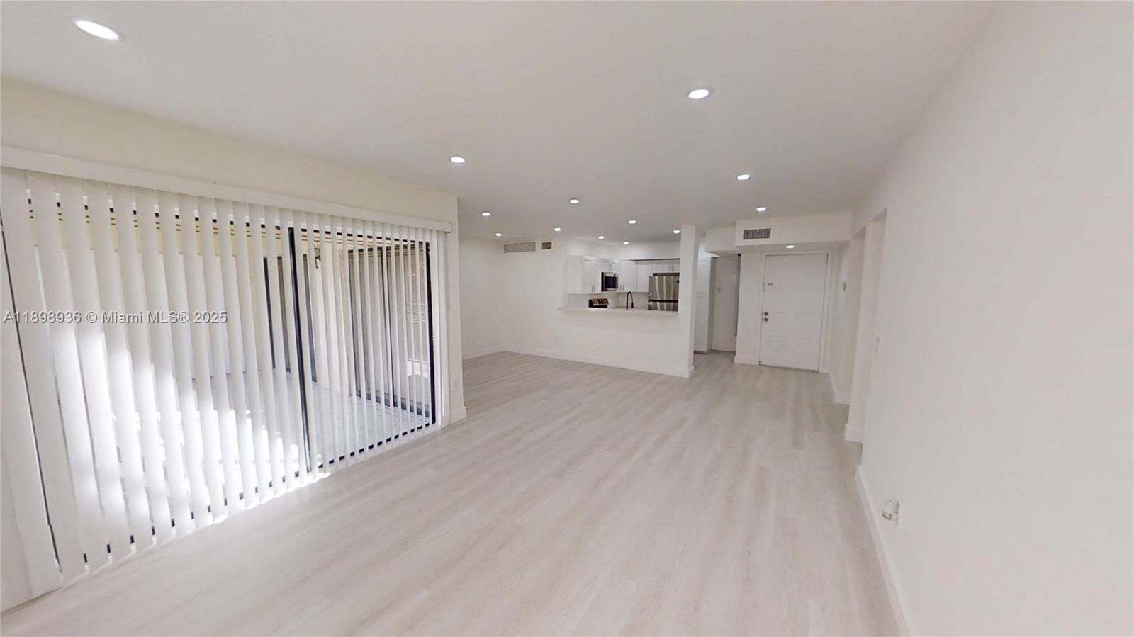 20230 Northeast 3rd Court, Unit 6 Miami, FL 33179 - Photo 38 of 44 a view of a big room with wooden floor and windows