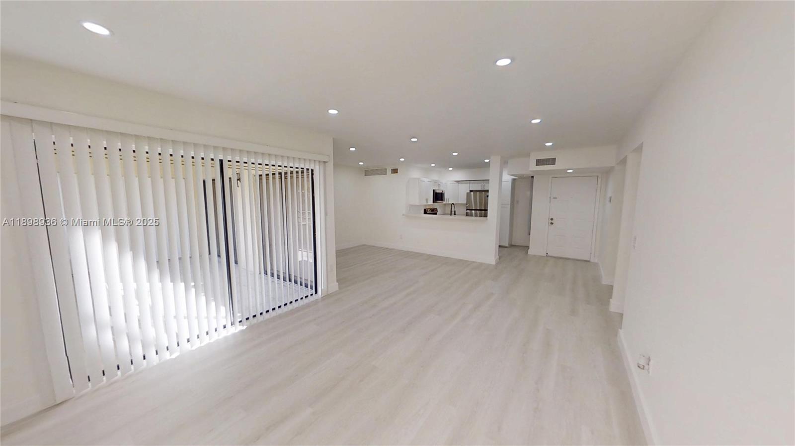 20230 Northeast 3rd Court, Unit 6 Miami, FL 33179 - Photo 39 of 44 a view of a big room with wooden floor and windows