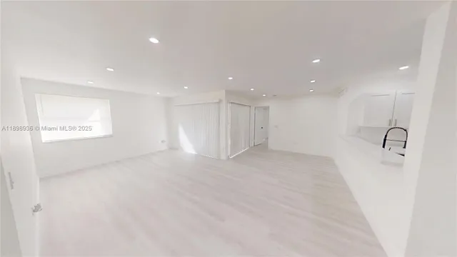 a view of a kitchen with a sink and a refrigerator