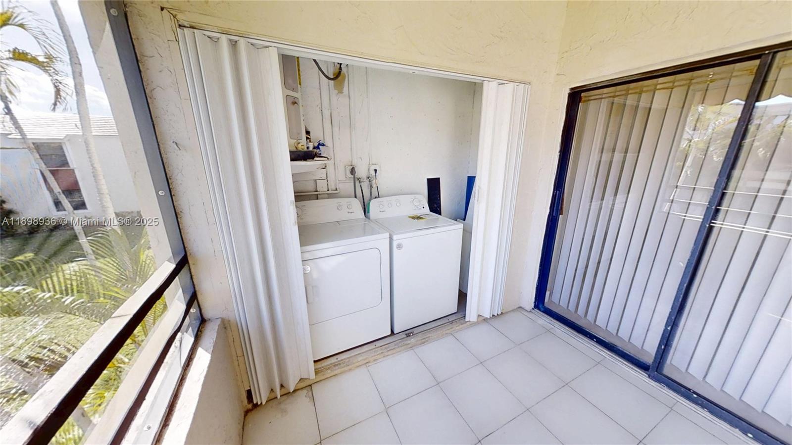 20230 Northeast 3rd Court, Unit 6 Miami, FL 33179 - Photo 41 of 44 a view of a hallway with washer and dryer