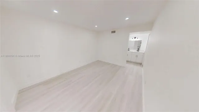 a view of a room with wooden floor and sink