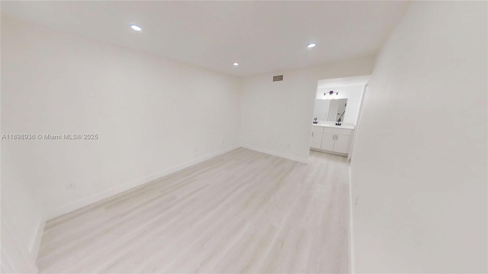 20230 Northeast 3rd Court, Unit 6 Miami, FL 33179 - Photo 9 of 44 a view of a room with wooden floor and sink