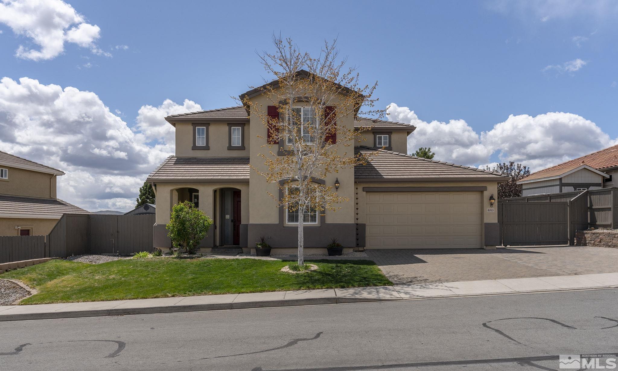 a front view of a house with a garden and plants