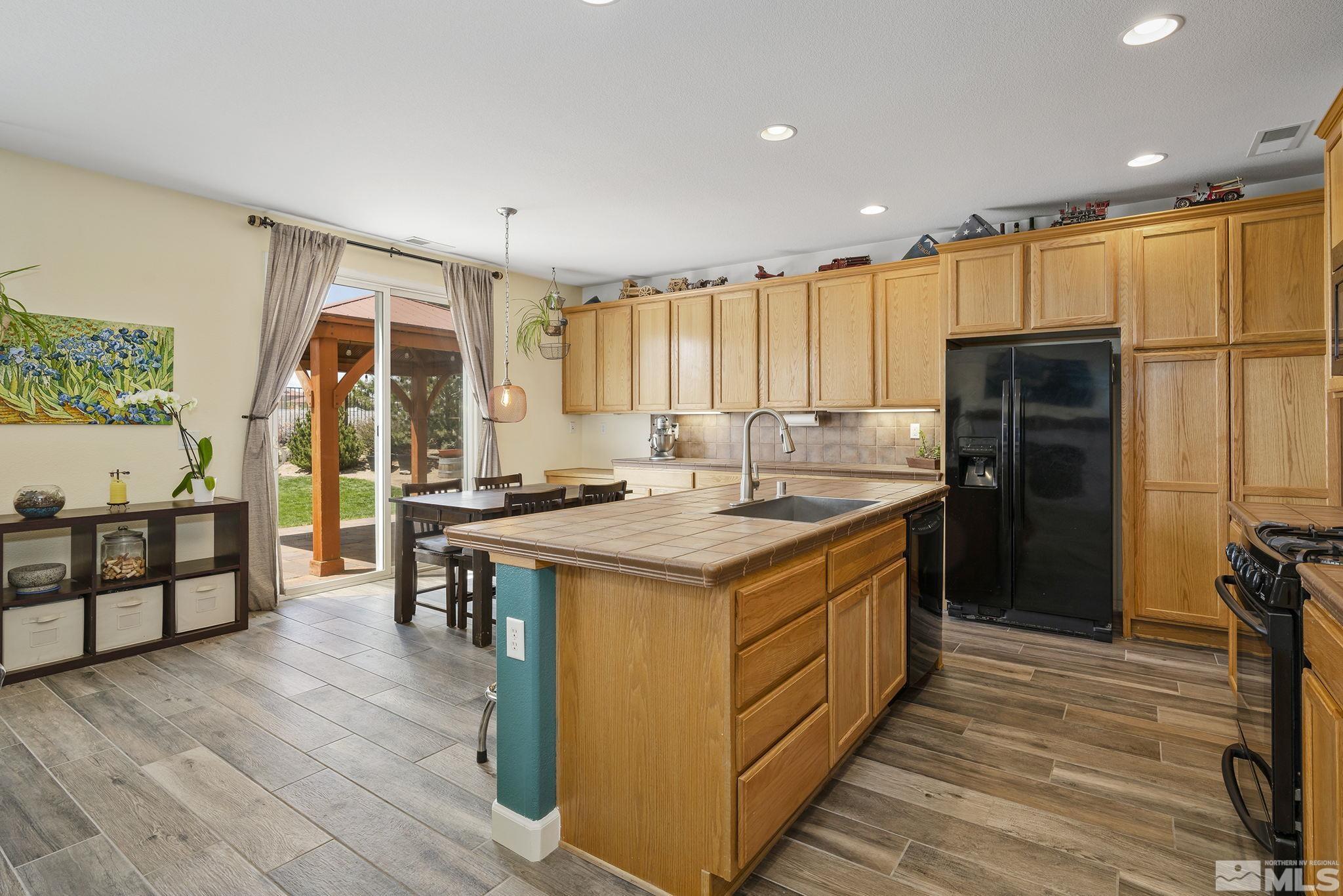 8065 Fire Opal Lane Reno, NV 89506 - Photo 15 of 31 a kitchen with stainless steel appliances granite countertop a stove and a refrigerator