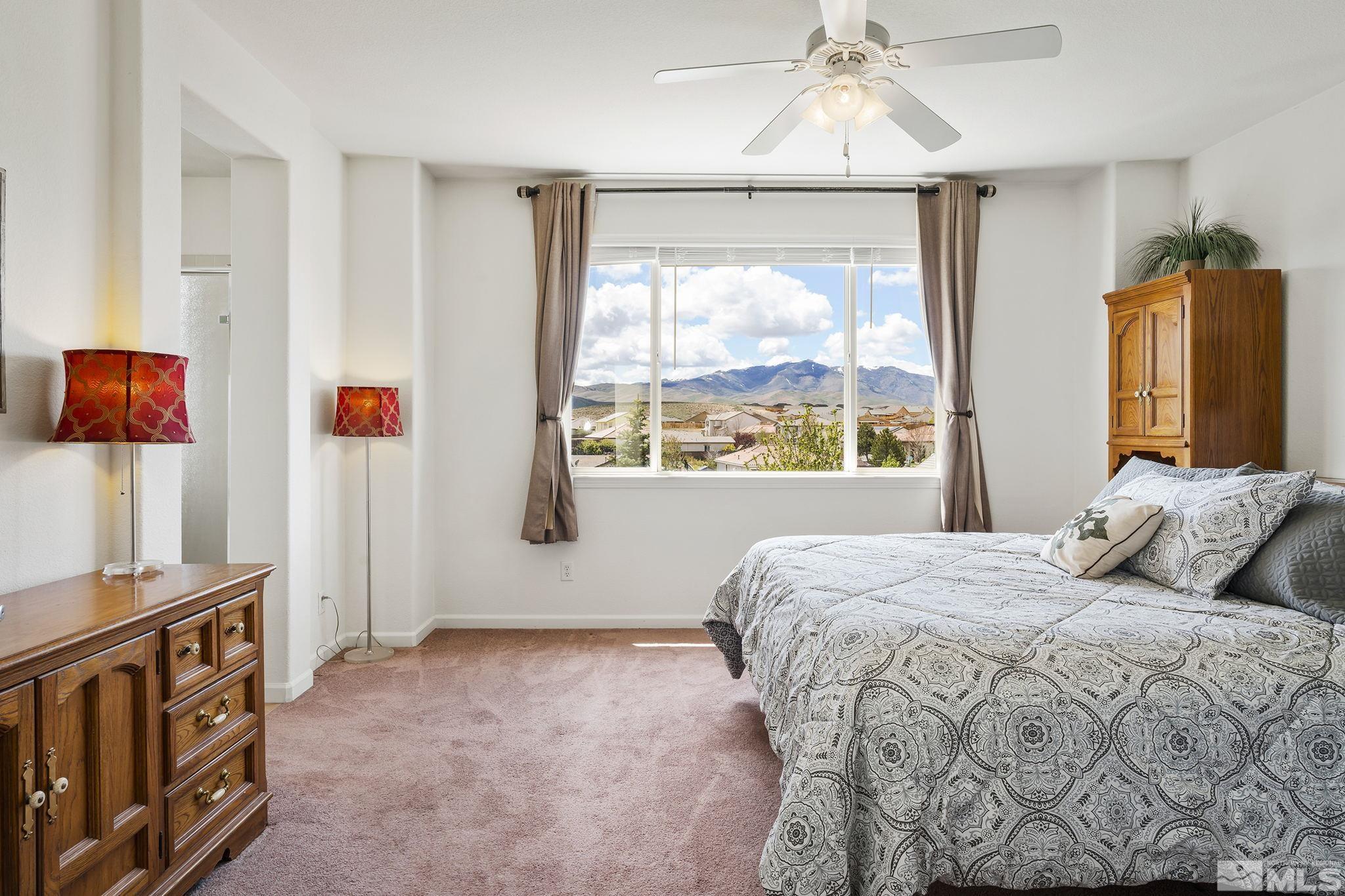 8065 Fire Opal Lane Reno, NV 89506 - Photo 19 of 31 a bedroom with a bed and a window