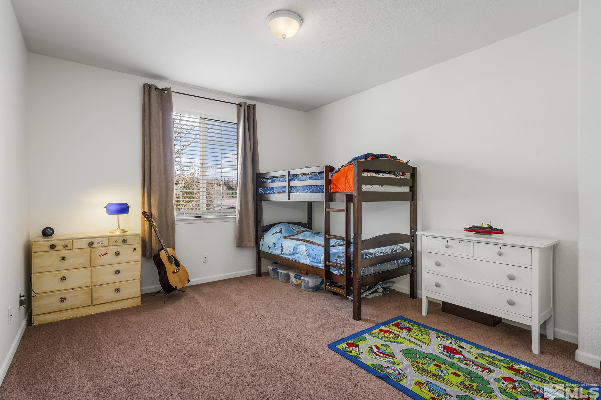 8065 Fire Opal Lane Reno, NV 89506 - Photo 22 of 31 a bedroom with furniture and a window