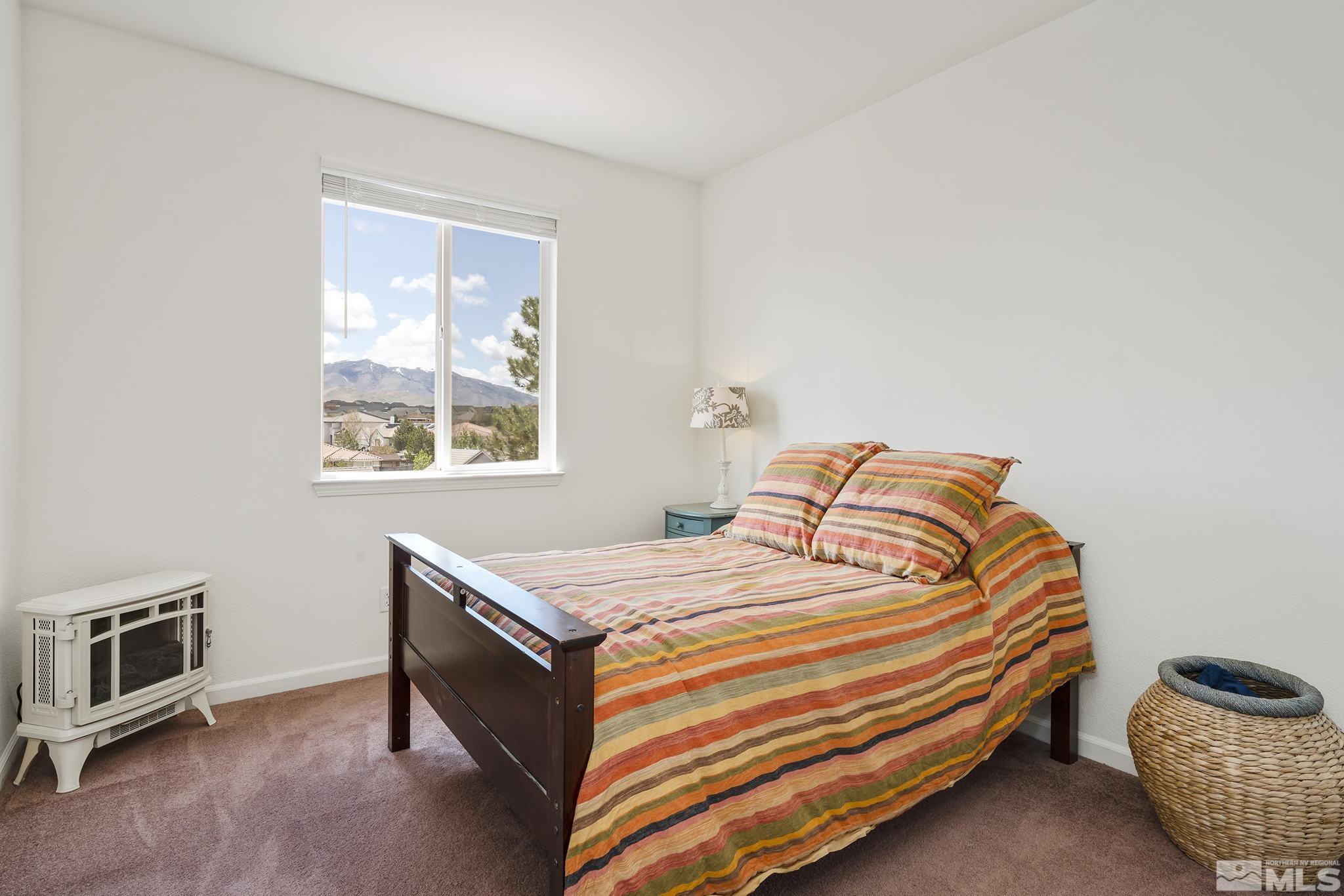 8065 Fire Opal Lane Reno, NV 89506 - Photo 23 of 31 a bedroom with a bed and a tv
