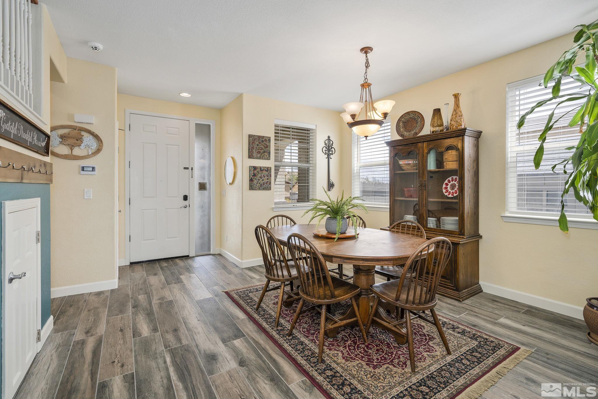 8065 Fire Opal Lane Reno, NV 89506 - Photo 25 of 31 a view of a dining room with furniture window and wooden floor