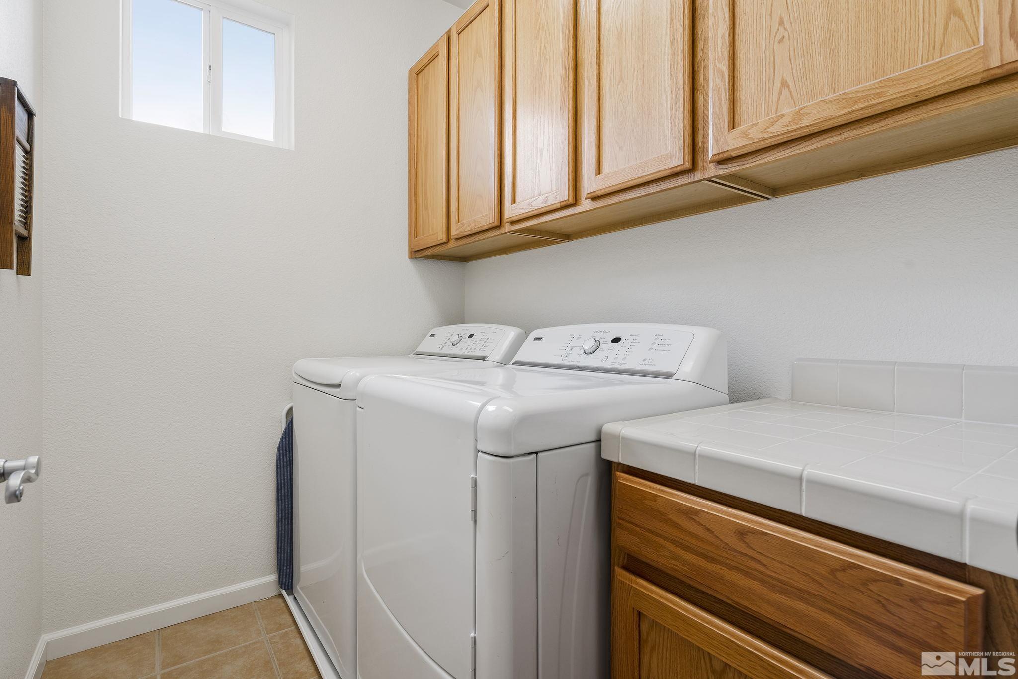 8065 Fire Opal Lane Reno, NV 89506 - Photo 26 of 31 a utility room with dryer and washer