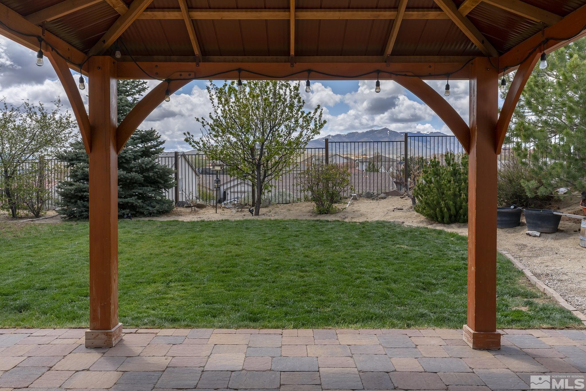 8065 Fire Opal Lane Reno, NV 89506 - Photo 28 of 31 a view of a backyard with table and chairs under an umbrella