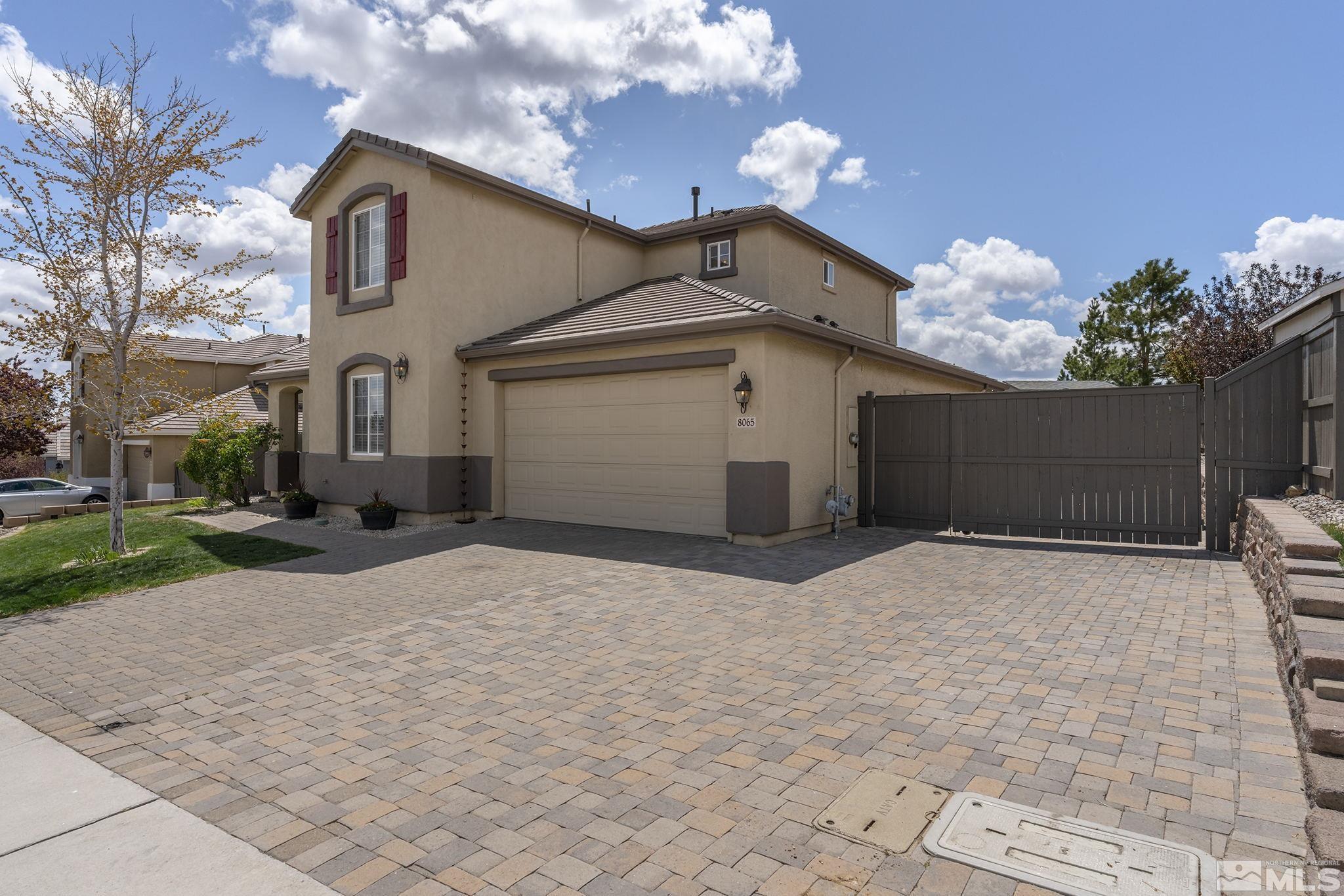 8065 Fire Opal Lane Reno, NV 89506 - Photo 30 of 31 a white house with a yard and a large tree