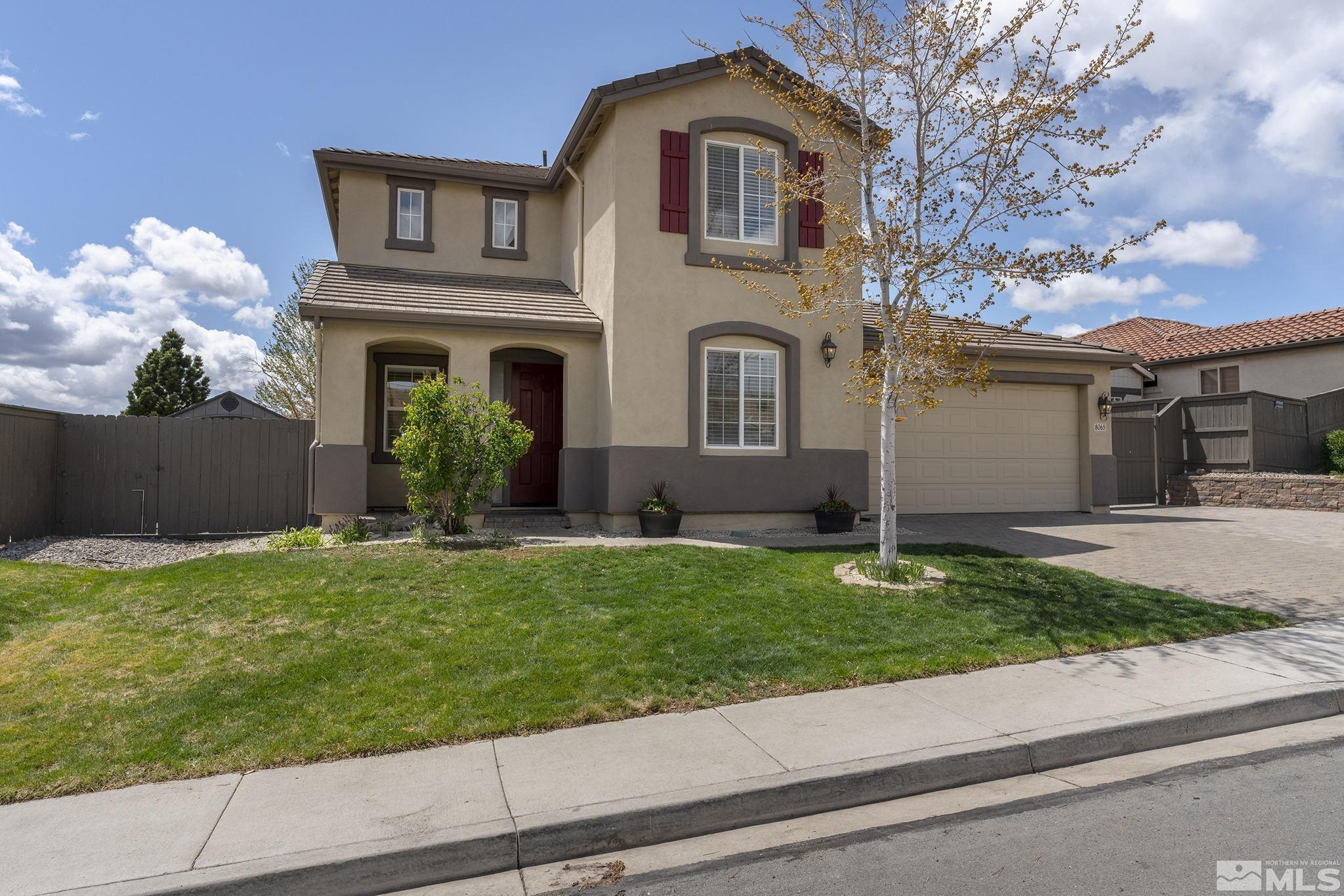 8065 Fire Opal Lane Reno, NV 89506 - Photo 31 of 31 a front view of a house with a yard and garage