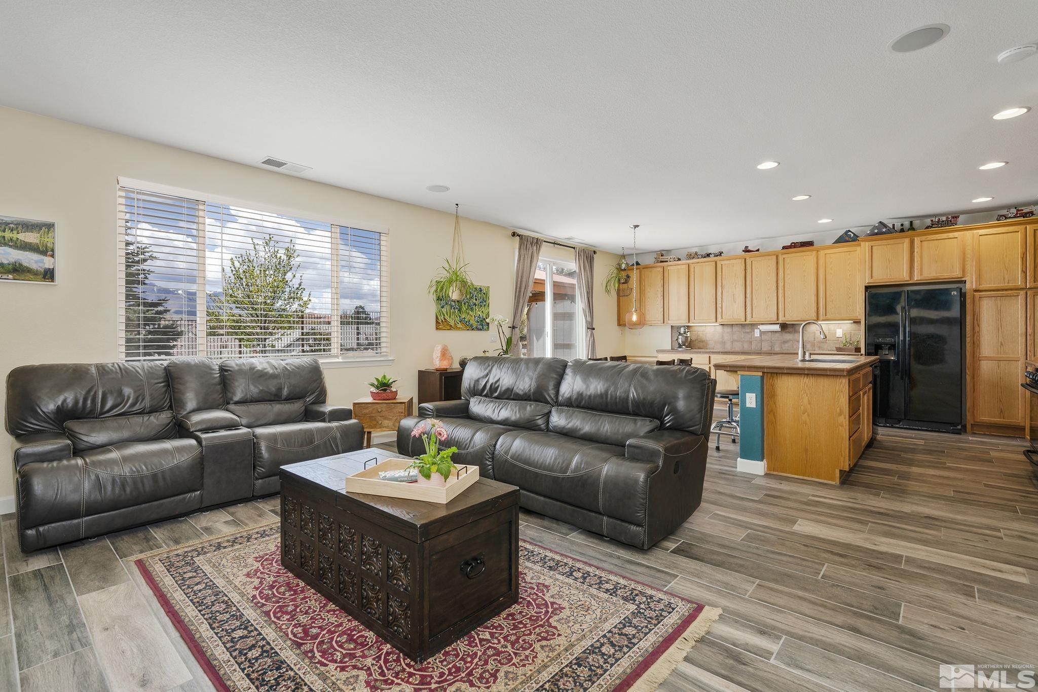 8065 Fire Opal Lane Reno, NV 89506 - Photo 4 of 31 a living room with stainless steel appliances furniture and a open kitchen view