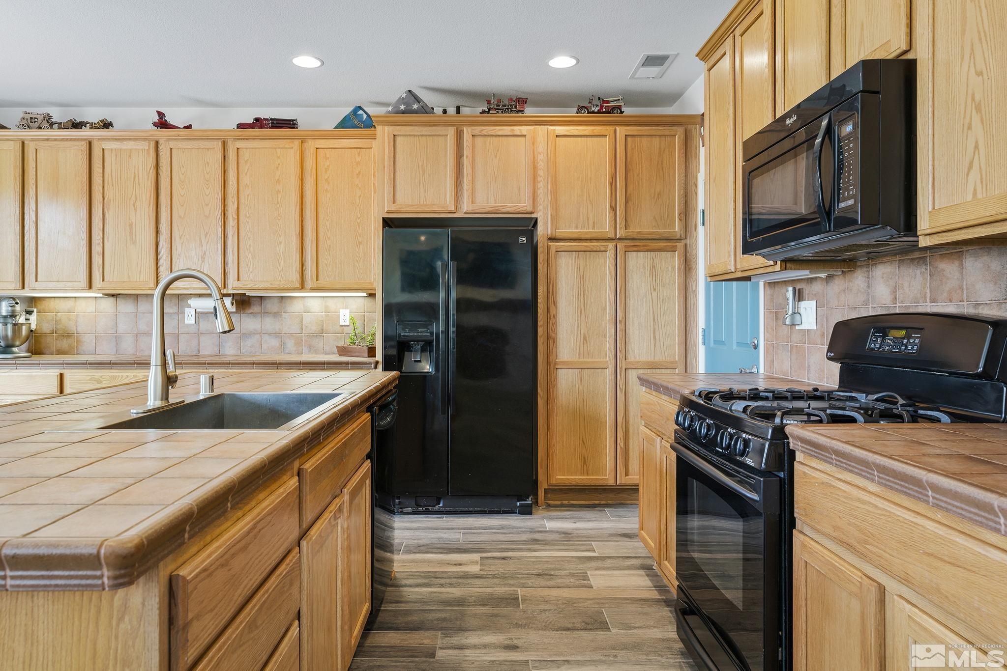 8065 Fire Opal Lane Reno, NV 89506 - Photo 5 of 31 a kitchen with stainless steel appliances granite countertop a stove a refrigerator and a sink