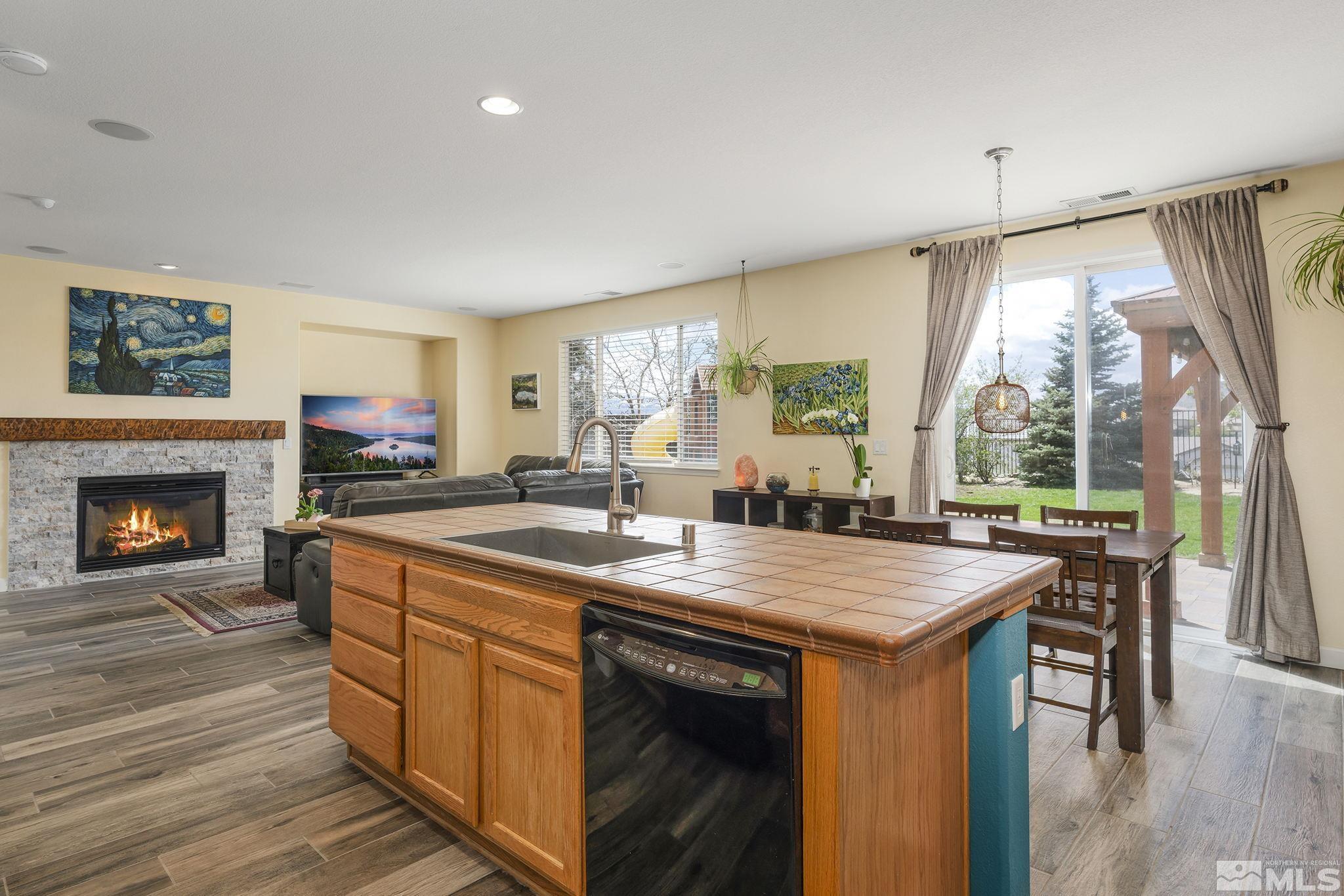 8065 Fire Opal Lane Reno, NV 89506 - Photo 6 of 31 a view of a kitchen with a sink and a fireplace