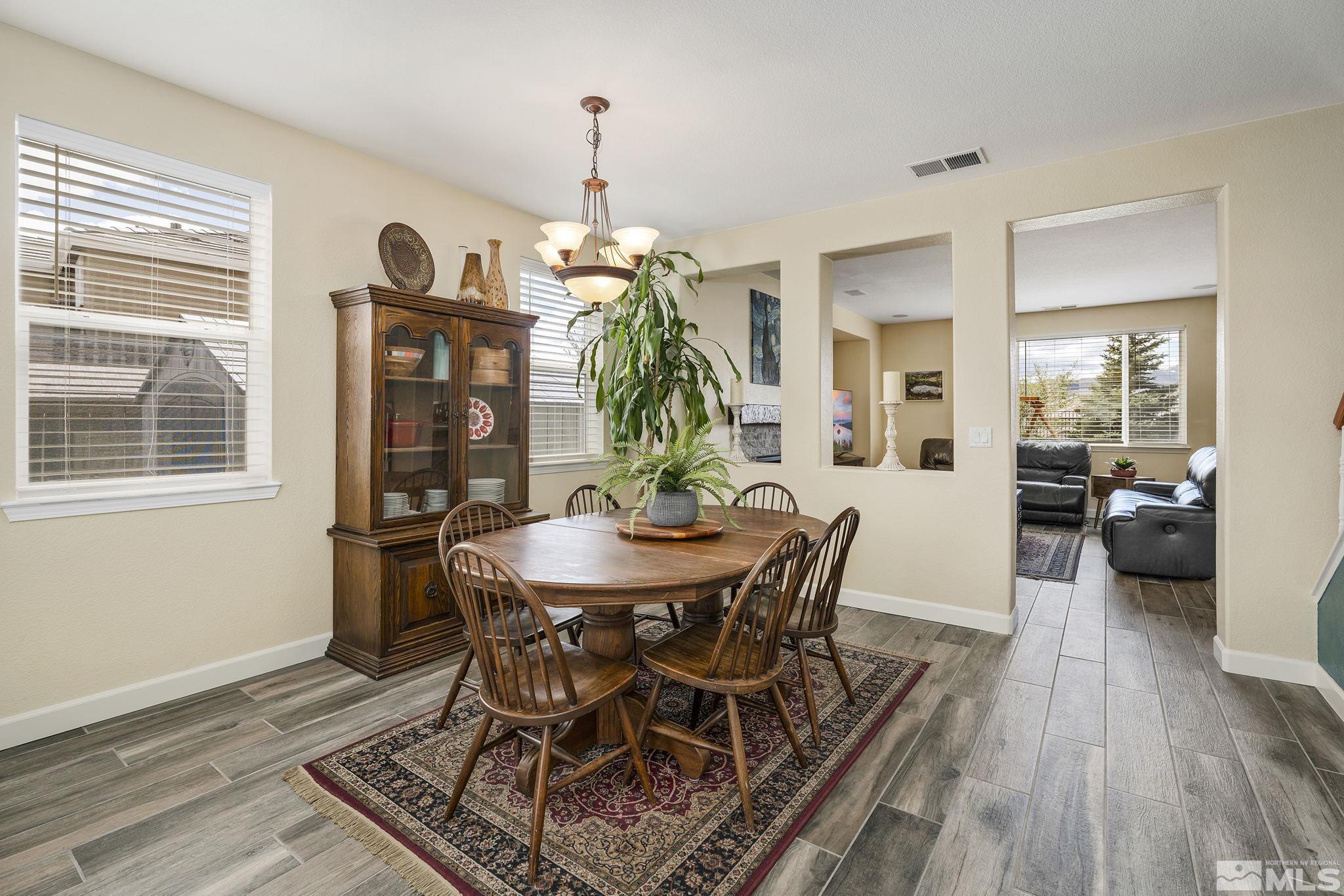 8065 Fire Opal Lane Reno, NV 89506 - Photo 7 of 31 a view of a dining room with furniture window and wooden floor
