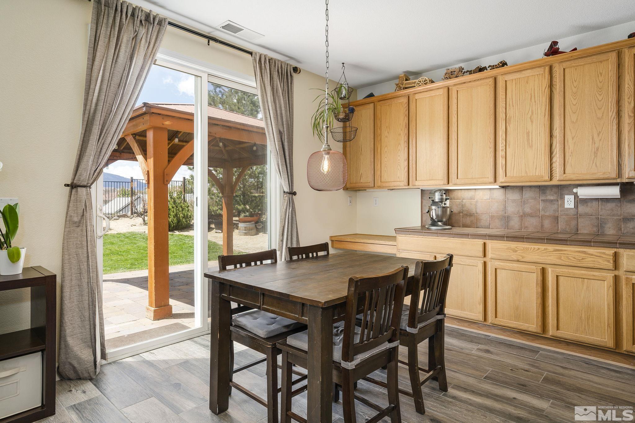 8065 Fire Opal Lane Reno, NV 89506 - Photo 8 of 31 a kitchen with a window a sink and dining table view